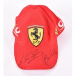 An official Ferrari F1 cap signed by Michael Schumacher and Rubens Barrichello the signatures to the