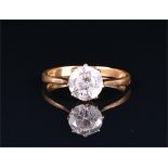 An 18ct yellow gold and solitaire diamond ring set with a round brilliant-cut diamond of