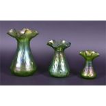 A graduated trio of Loetz Crete Rusticana glass vases each of tapering cylindrical form with