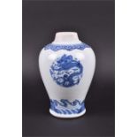 A Chinese Kangxi period blue and white baluster jar the body decorated with three roundels depicting