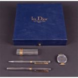 A Christian Dior les Dior cased lighter, pen and watch set comprising a silver plated cigarette