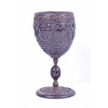 A small 17th century carved coconut mazer cup or goblet with white metal mounts the bowl carved with