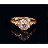 An 18ct yellow gold and diamond floral cluster ring set with old cut diamonds, the central stone