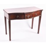 A George III style mahogany serpentine-fronted serving table with two drawers on fluted tapering