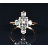 A 9ct yellow gold and green apatite cluster ring the kite-shaped cluster set with eight oval-cut