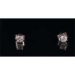 A pair of 18ct white gold and solitaire diamond ear studs set with round brilliant-cut diamonds,