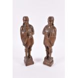 A pair of early 20th century carved oak figures of medieval soldiers on square bases, each 48 cm