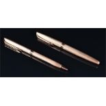 A Waterman 9ct gold fountain pen and ballpoint pen set engine turned overall, no box. (2)