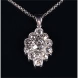 A white metal and diamond Art Deco cluster pendant centred with an old cut diamond, surrounded by