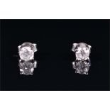 A pair of 18ct white gold and solitaire diamond ear studs the stones of approximately 0.79 carats