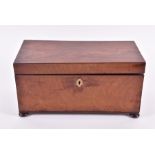 A Georgian tea mahogany caddy  with brass escutcheon on four bun feet, the interior with silk-