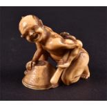 A finely carved 19th century Japanese ivory netsuke depicting a rat catcher the crouching male