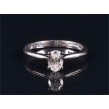 A platinum and diamond single stone ring the oval brilliant diamond weighing approximately 0.41