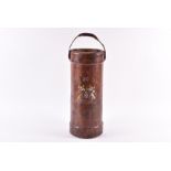 An early 20th century leather munitions carrier adapted as a stick stand bearing an armorial