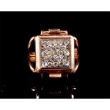 A novelty gold plated Arcadia watch ring the hinged cover set with white paste stones, Arabic