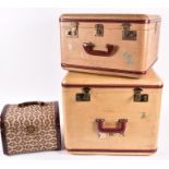 A graduated pair of mid 20th century hard shell suitcases by Cheney the largest 42 cm high x 48 cm