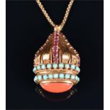 An unusual yellow metal, ruby, coral, and turquoise pendant the set to the underside with an oval