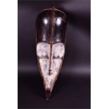 A mid 20th century hardwood Fang mask Gabon, with white painted face, 74 cm high.