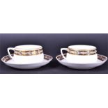 A pair of early 20th century Russian Gardner Porcelain cups and saucers circa 1908, the borders with