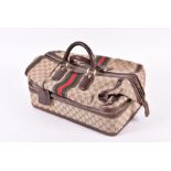 A Vintage Gucci monogrammed Weekender travel bag  with leather handles and separate compartment to