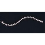 An 18ct white gold and diamond tennis bracelet the twenty-eight rubover set round brilliant-cut