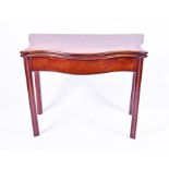 A George III serpentine fronted mahogany card table on triangular front supports, 85 cm wide.