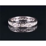 An 18ct white gold and diamond eternity ring channel set with round brilliant-cut diamonds, size L