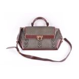 A Salvatore Ferragamo leather handbag of olive green basket-weave form with stitched brown handle