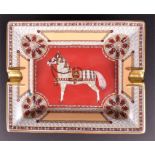 A Hermes rectangular ashtray decorated with a central saddled horse and a patterned wheel to each