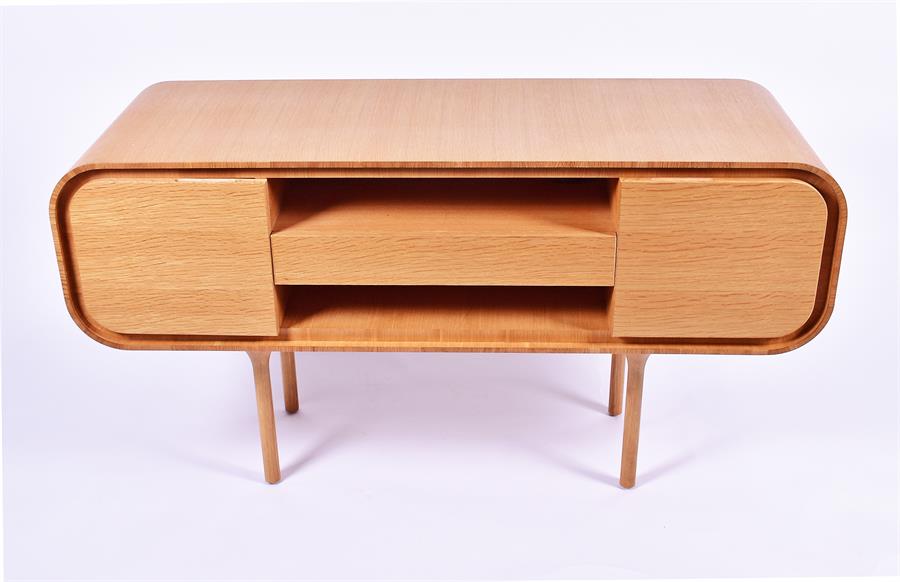 A Heal's sideboard in the 1960s style with a single central drawer between open shelves, flanked