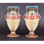 A pair of late 19th century Minton twin-handled pedestal vases of flared-rim baluster form, with