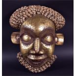 A mid-20th century Bamun mask Cameroon, circa 1940, with gilt finish to the face and stylised hair