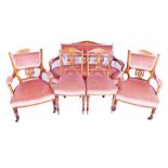 An Edwardian five-piece salon suite comprising a two-seater sofa (137cm wide), a pair of armchairs