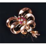 A ruby and diamond spray brooch the spray centred on a cluster of round brilliant-cut diamonds and