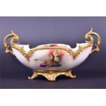 A Royal Worcester twin-handled oval bowl with shaped gilt rim  on a deep gilt base with four