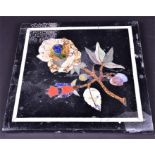 An old pietra dura marble panel the black ground decorated with a floral group set within white