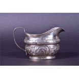 A George III Irish silver cream jug maker's mark unknown, Dublin 1806, with repousse foliate