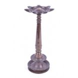 An early Eastern bronze oil burning pedestal lamp, believed to be Indian of tapering cylindrical