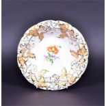 A 19th century Meissen porcelain plate with moulded foliate relief border with gilded highlights