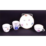 A small hand painted Meissen cup and saucer the cup with applied moulded foliate handle, 7 cm