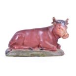 A large early 20th century painted plaster model of a seated bull, probably from a butcher's