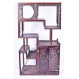 An impressive early 20th century eight section Chinese carved hardwood display stand the base fitted