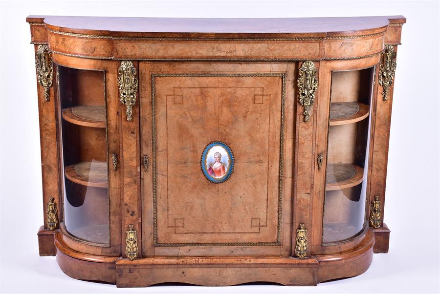 A Victorian walnut cross-banded and gilt metal mounted credenza the shaped top over a central