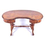 A Victorian figured walnut kidney shaped writing desk with inset leather top over two small