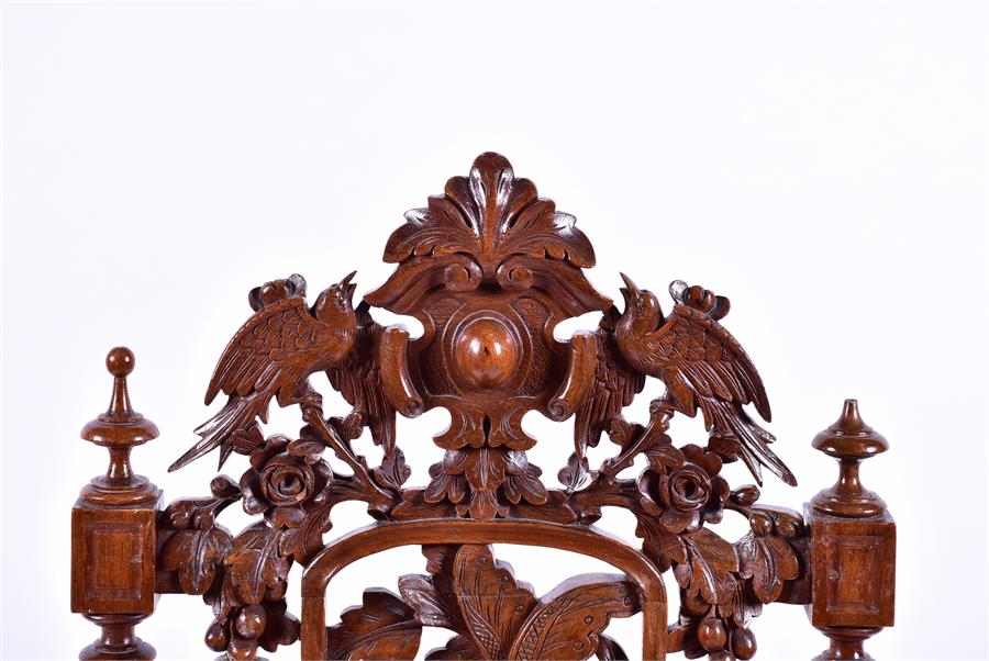 An early 20th century oak side chair with detailed armorial carving over pierced acorn, leaf and - Image 4 of 6