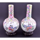 A Pair of hand painted export Chinese porcelain famille rose vases of bulbous form with tall