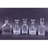 A group of four good quality clear cut crystal decanters to include a Baccarat example of squared