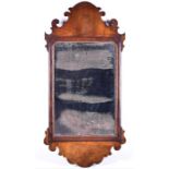 An early 19th century mahogany wall mirror with fret carved decoration, the glass 49 cm x 31 cm.