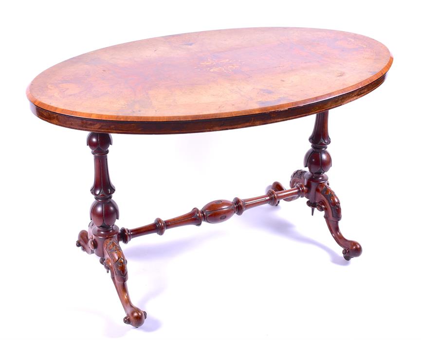 A Victorian figured walnut oval stretcher table the top with floral inlay and angled rim,