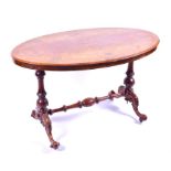 A Victorian figured walnut oval stretcher table the top with floral inlay and angled rim,